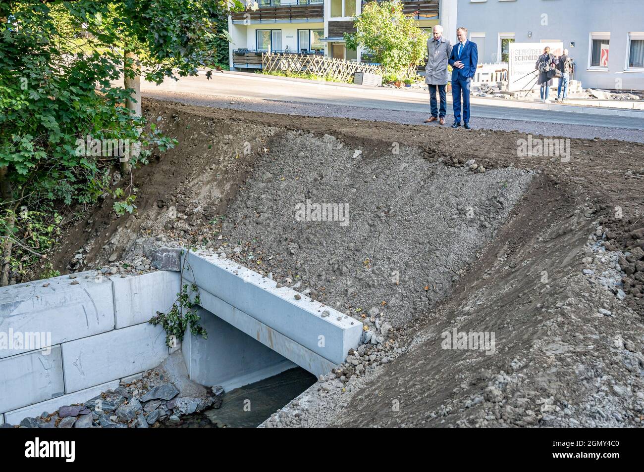 Hagen, Germany. 21st Sep, 2021. State Secretary Dr. Hendrik Schulte (r) inspects the construction site with Ludger Siebert (NRW State Road Construction Authority). In the Priorei district of Hagen, a bridge on the 701 trunk road (Osemundstraße) was inaugurated today after being rebuilt. The bridge was destroyed by the flood disaster last July and completely rebuilt in only two months construction time. Credit: Markus Klümper/dpa/Alamy Live News Stock Photo