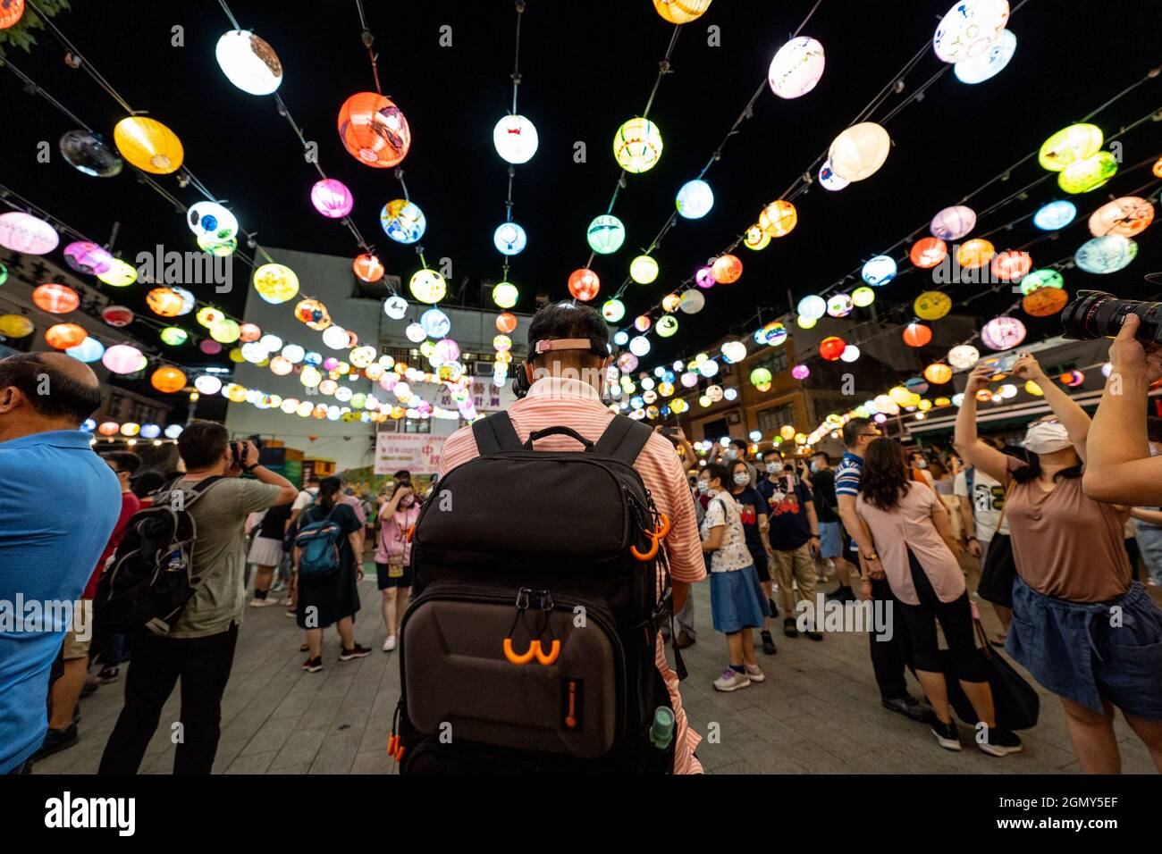 Hong Kong, China. 20th Sep, 2021. People take photos of lanterns and light  decorations set up for Mid-Autumn Festival.Tai O, a small fishing village  in Hong Kong, annually decorates the area with