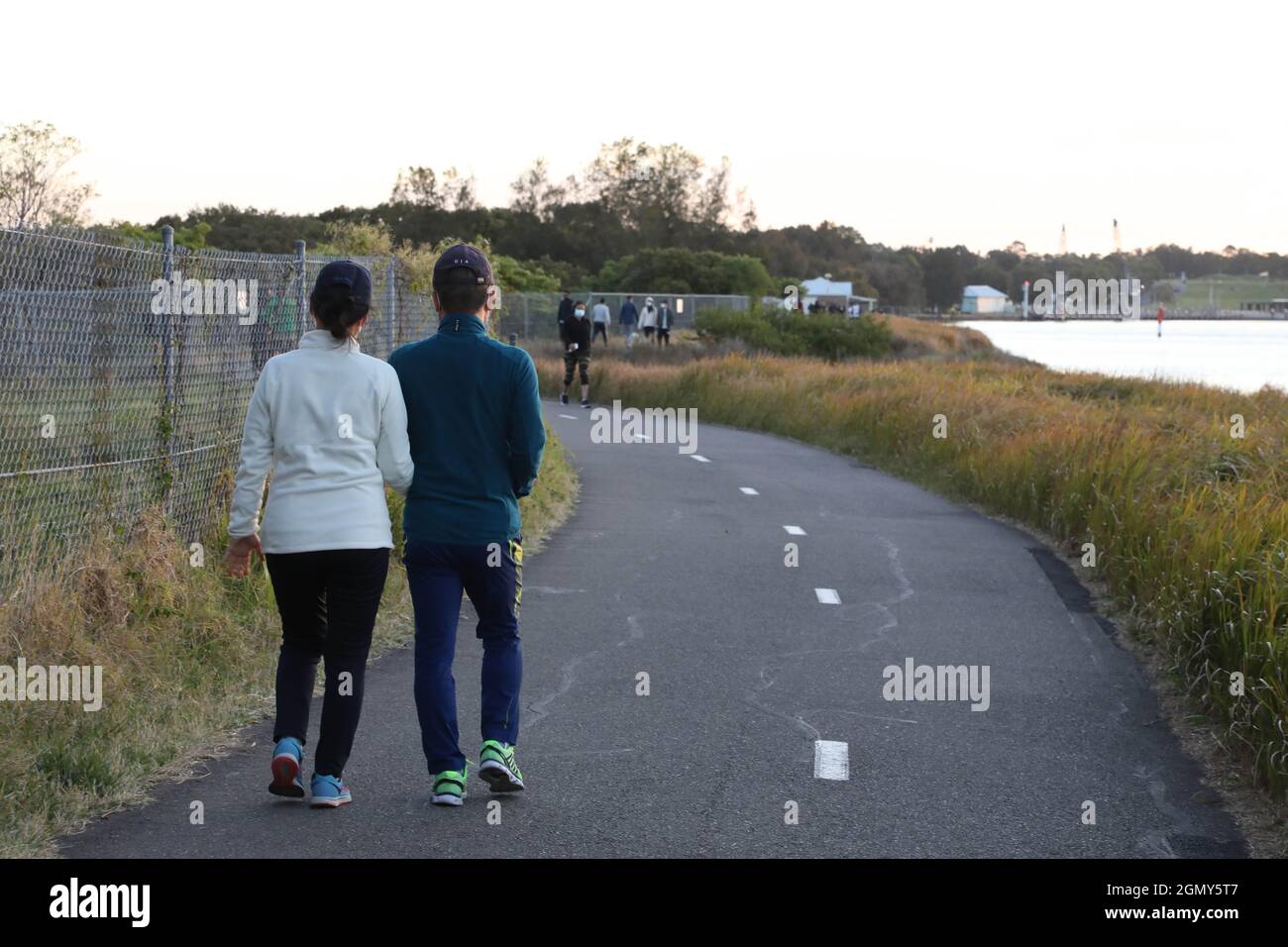 Sydney, Australia. 21st September 2021. People exercise next to the Parramatta River at Newington, Sydney Olympic Park. Credit: Richard Milnes/Alamy Live News Stock Photo