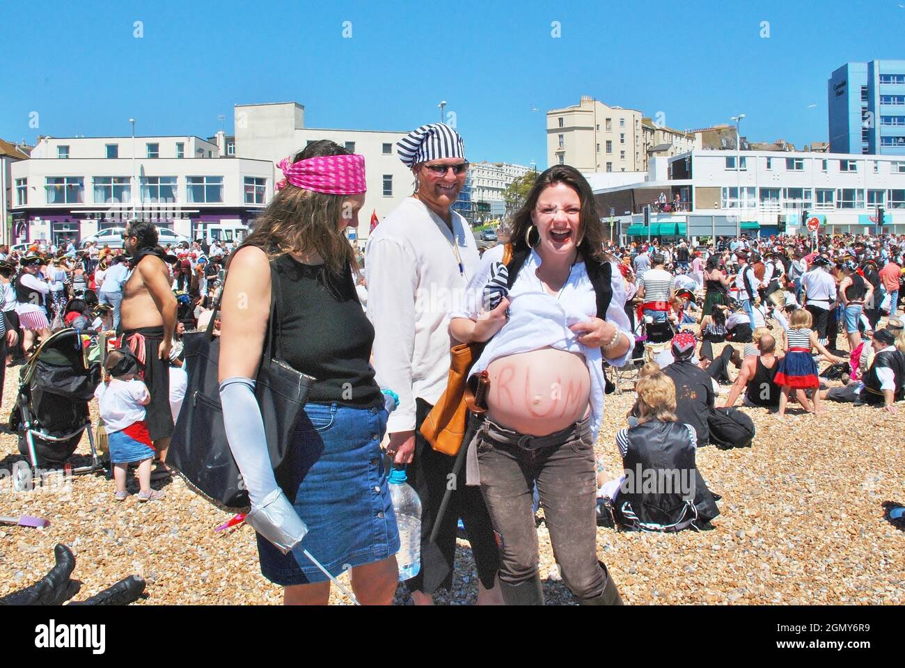 People dressed as pirates take part in the Pirate Day event on the beach at Hastings in East Sussex, England on July 22, 2012. Started in 2009, it was an attempt to win the Guinness World Record for the largest number of pirates gathered on the beach. Stock Photo