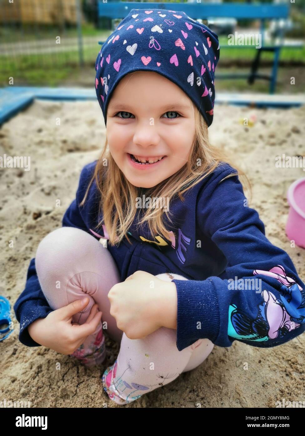 Cute Caucasian girl playing on the playground in the sandpit Stock ...