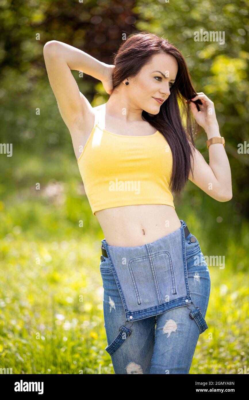 Lady standing in blue jeans hi-res stock photography and images - Alamy