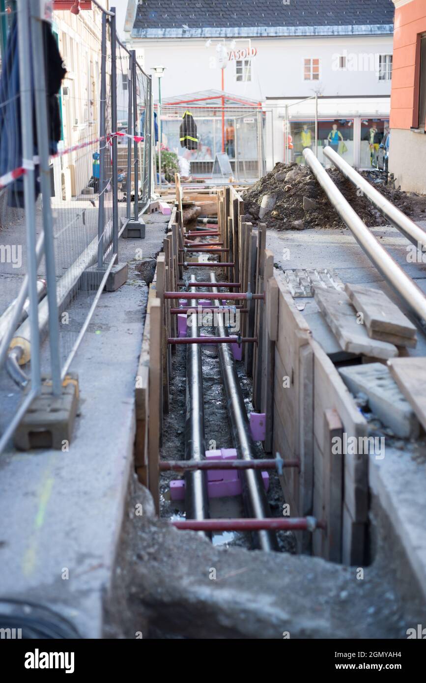 LIEZEN, AUSTRIA - Dec 09, 2020: A vertical documentary shot of pipes laid in the street at a construction site in Liezen, Austra Stock Photo