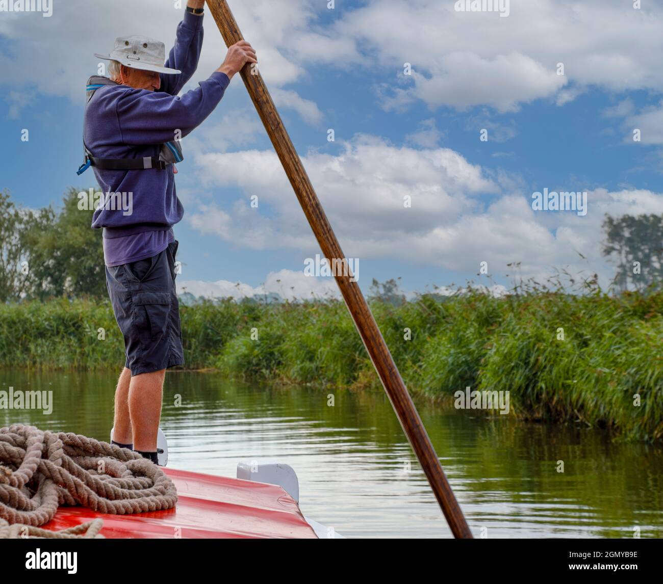 Moving a wherry with a pole on the Norfolk broads. Stock Photo