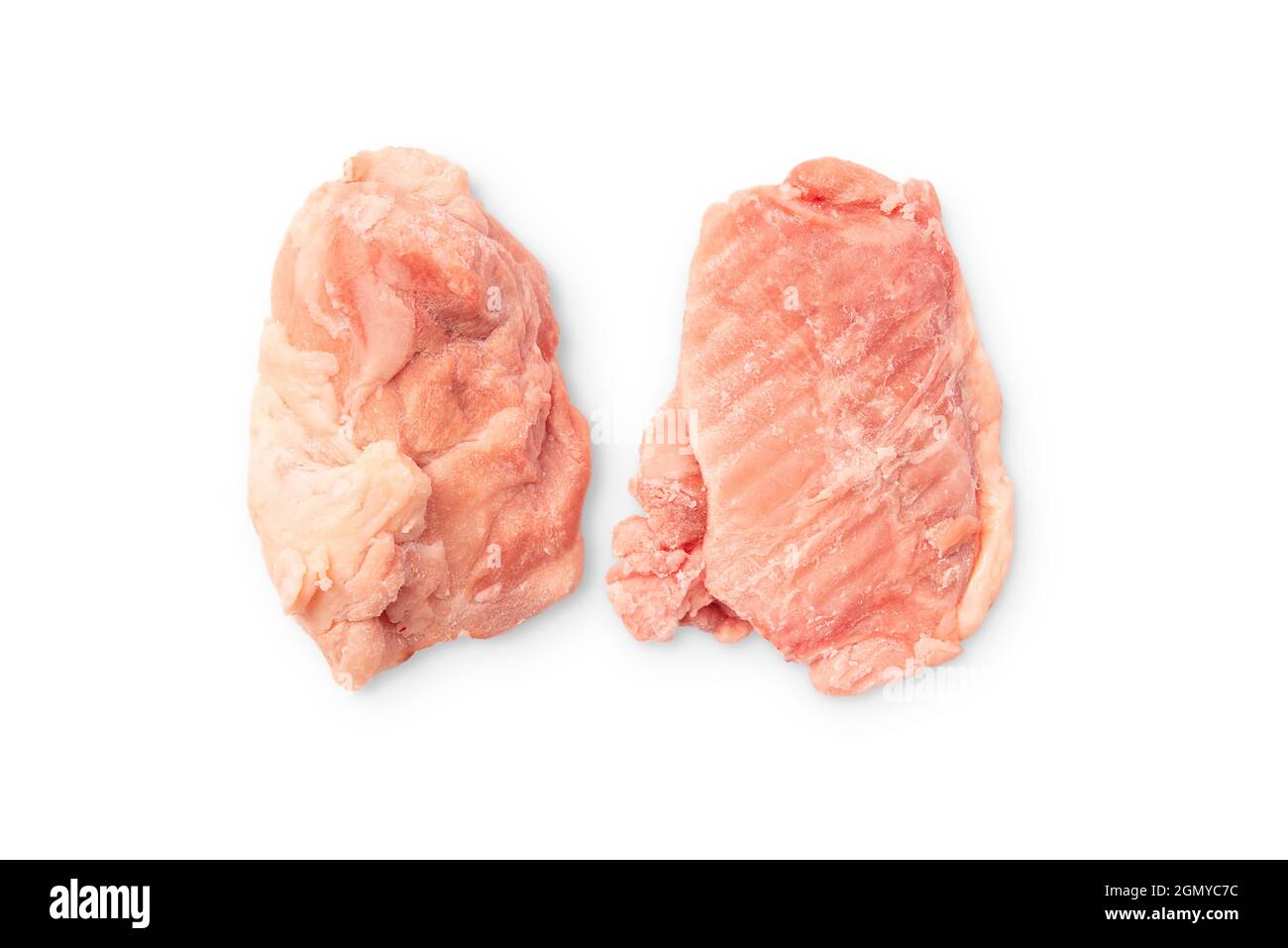 Two Raw frozen boneless chicken thighs on a white background.Lots of