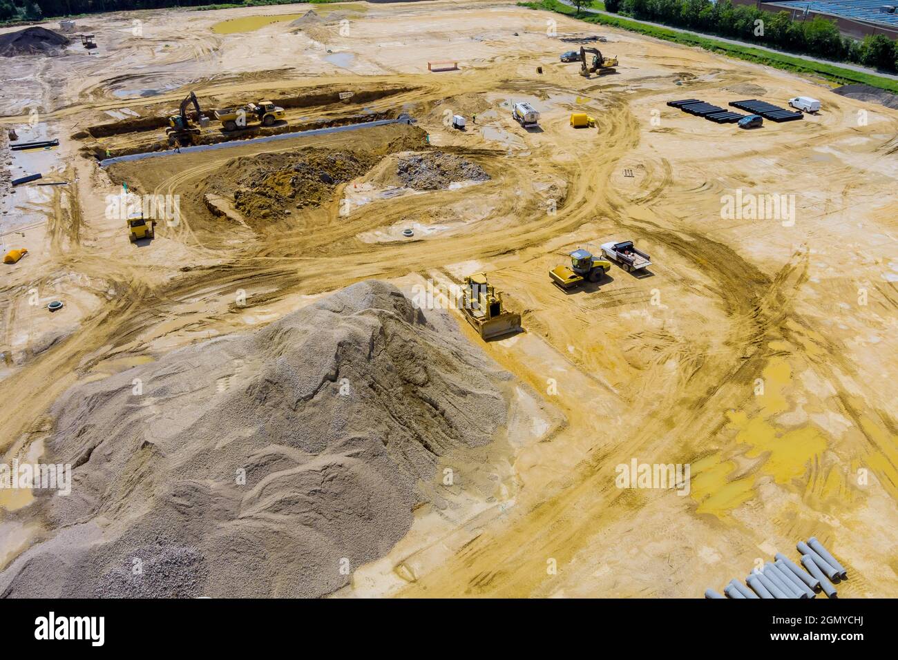Aerial view of sewerge construction trench for laying external sewage drainage system construction at earthworks Stock Photo