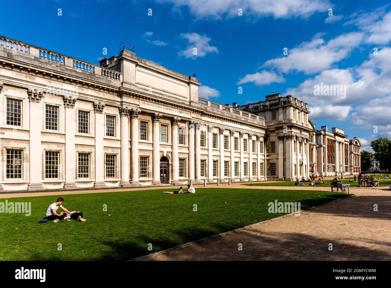 Young People Sitting In The Gardens At The Old Royal Navy College, Greenwich, London, UK. Stock Photo