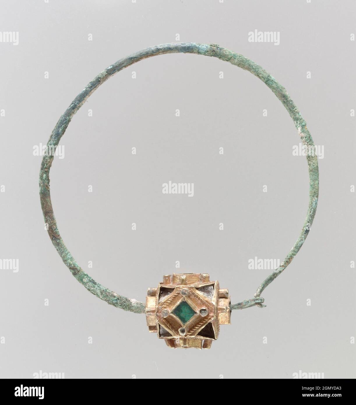 Earring. Date: 6th-7th century; Culture: Frankish; Medium: Gold, green and clear glass, pearls(?); hoop copper alloy or base silver; Dimensions: Stock Photo