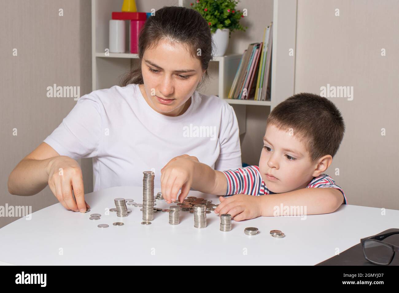 Mother and child learn financial literacy for children, to invest