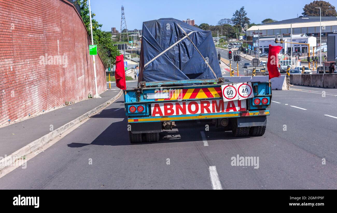 Industrial transportation rigging truck rear carrying abnormal heavy machine load on the road. Stock Photo
