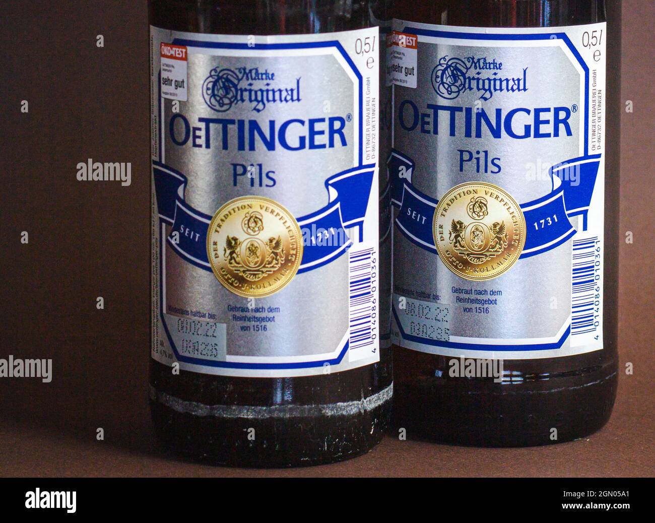 Neckargemuend, Germany - September 13, 2021: two labels of oettinger brand pilsner beer, best selling german brewery group with focus on right bottle. Stock Photo