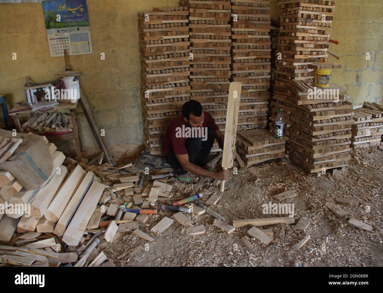 Srinagar, India. 19th Sep, 2021. A worker produce cricket bats in a