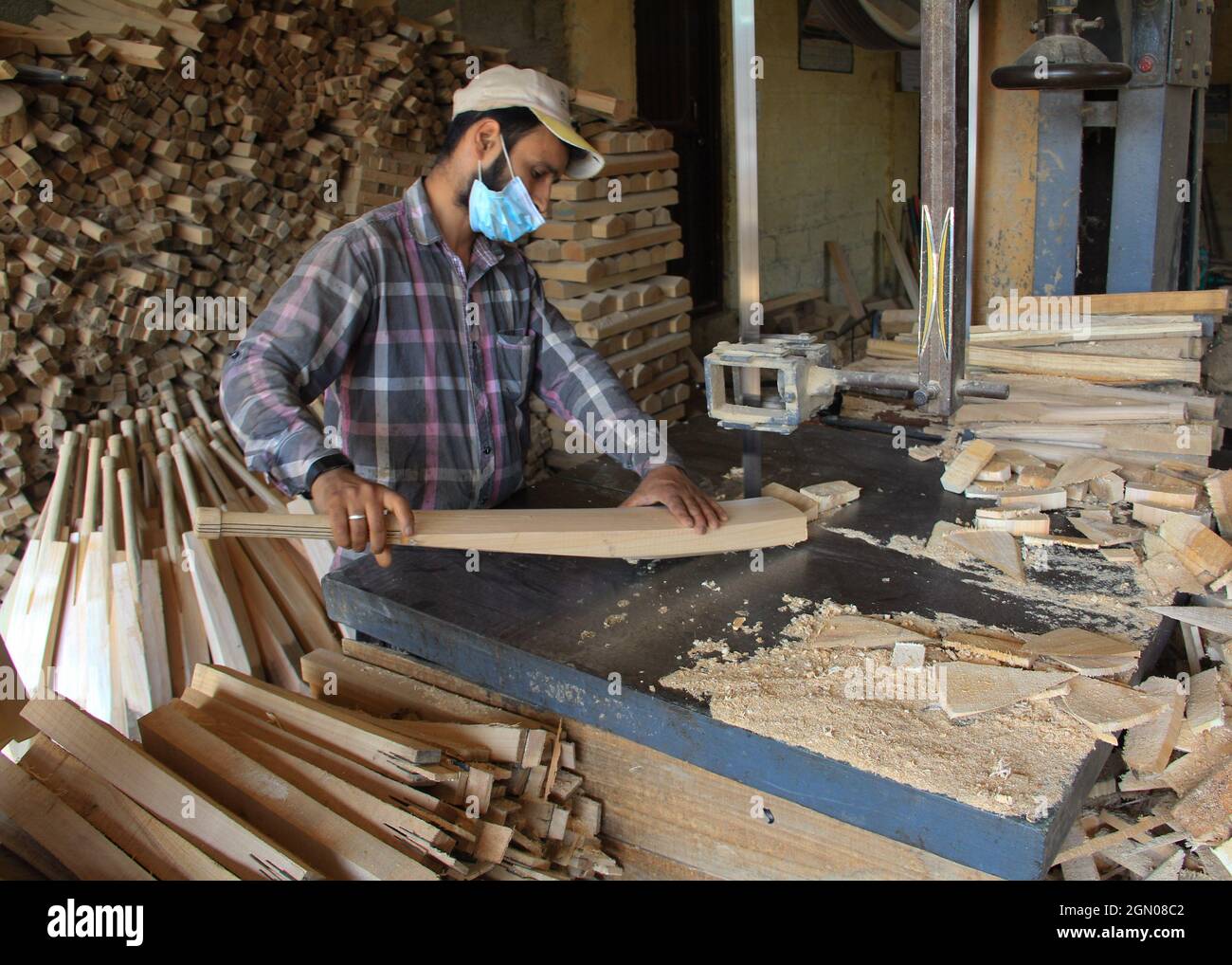 Srinagar, India. 19th Sep, 2021. A worker produce cricket bats in a