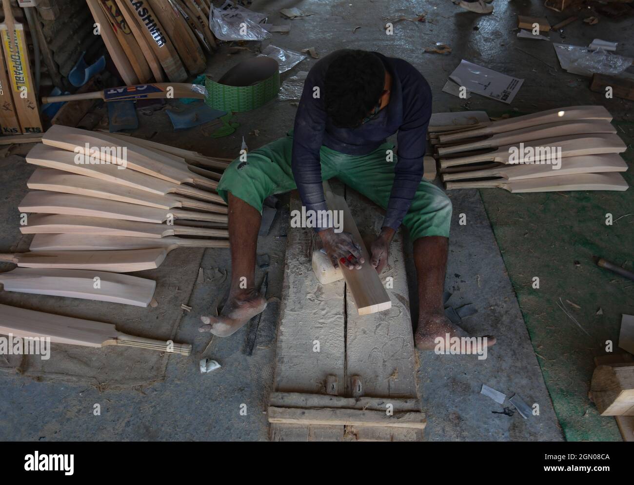 Srinagar, India. 19th Sep, 2021. A worker produce cricket bats in a