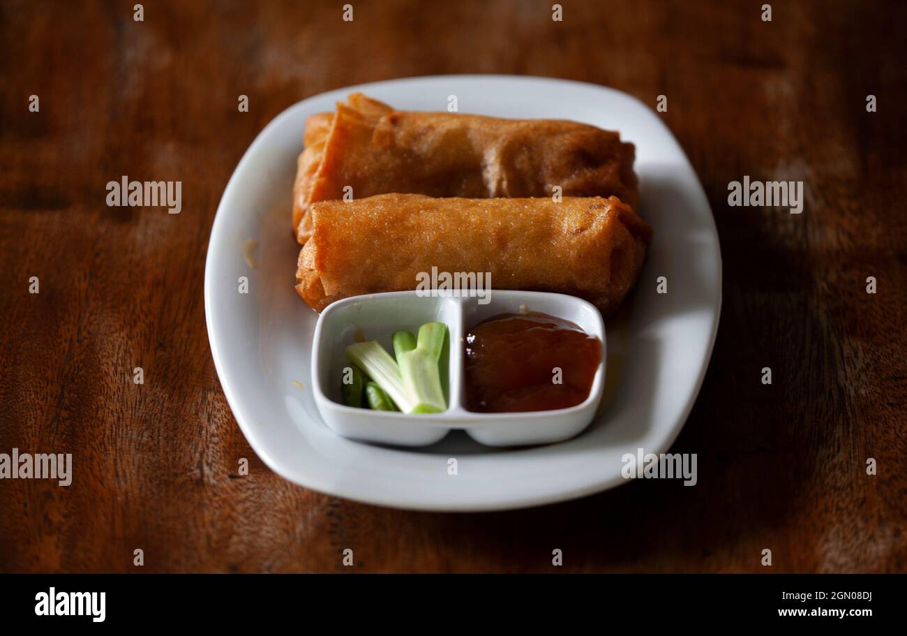 Lumpia on a white plate with chili sauce and chili sauce. Lumpia is a typical food from Indonesia Stock Photo