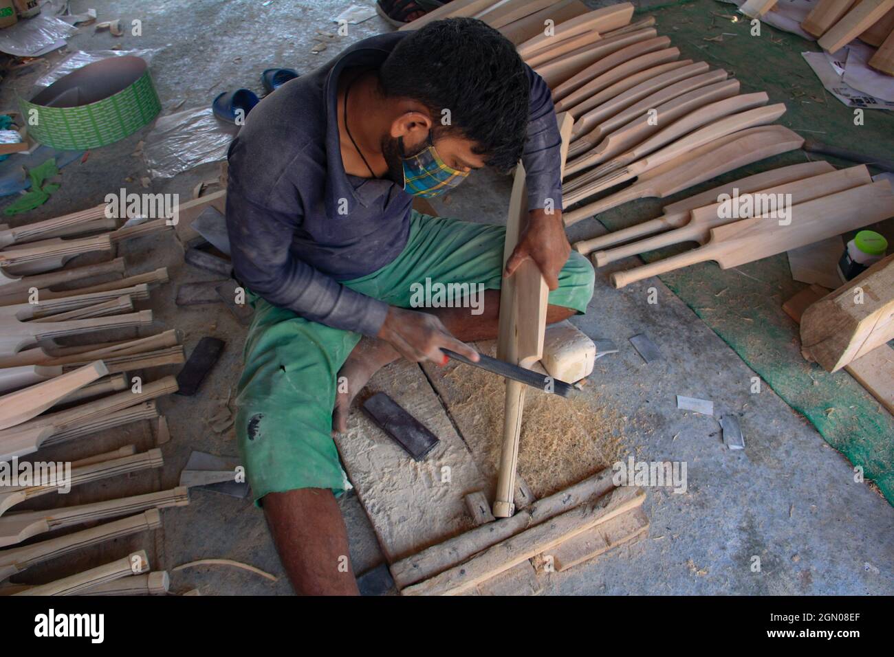 Srinagar, India. 19th Sep, 2021. A worker produce cricket bats in a