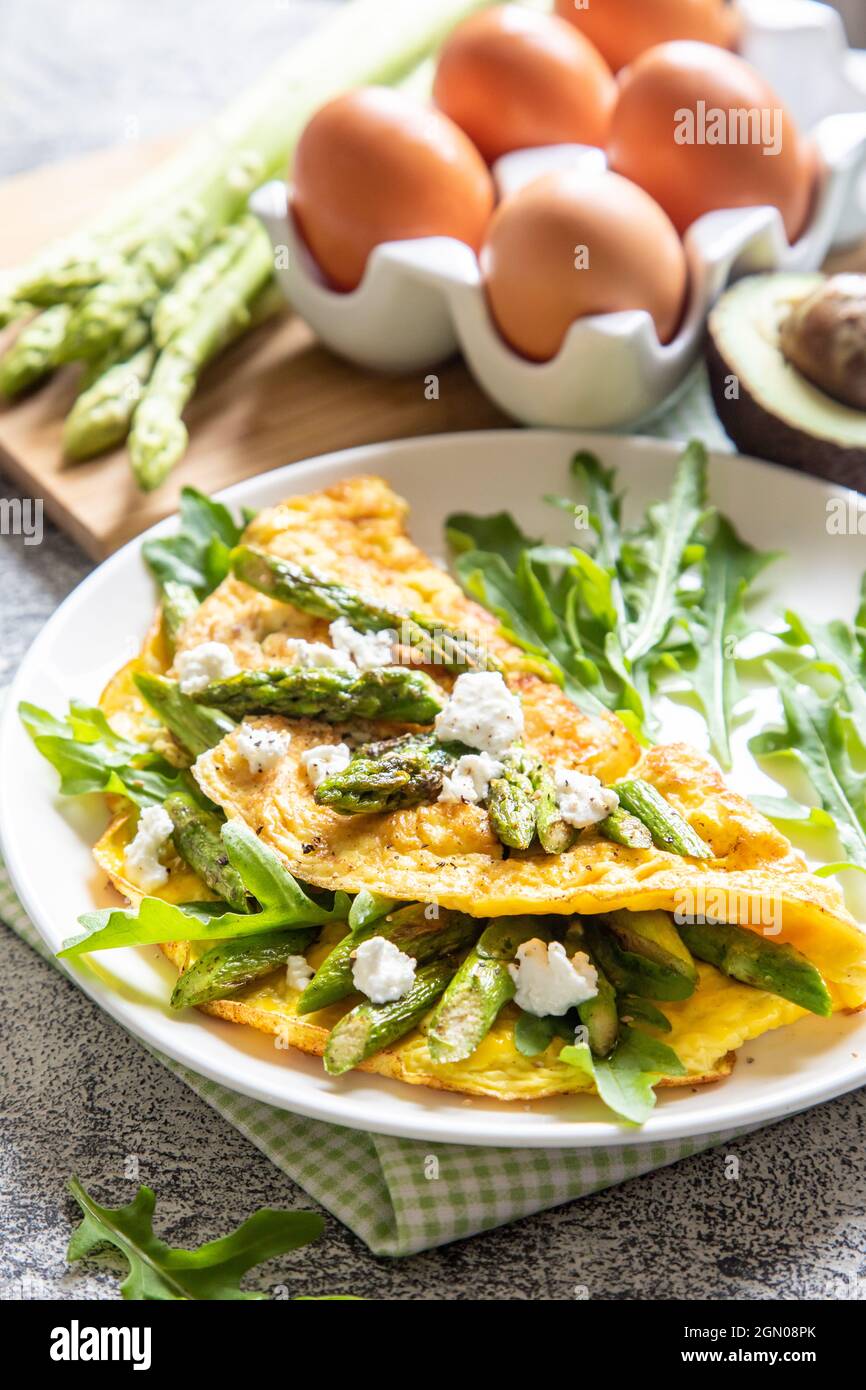 Gourmet Tasty Egg Omelette with Asparagus and soft Cheese. Asparagus. Fresh Asparagus with eggs