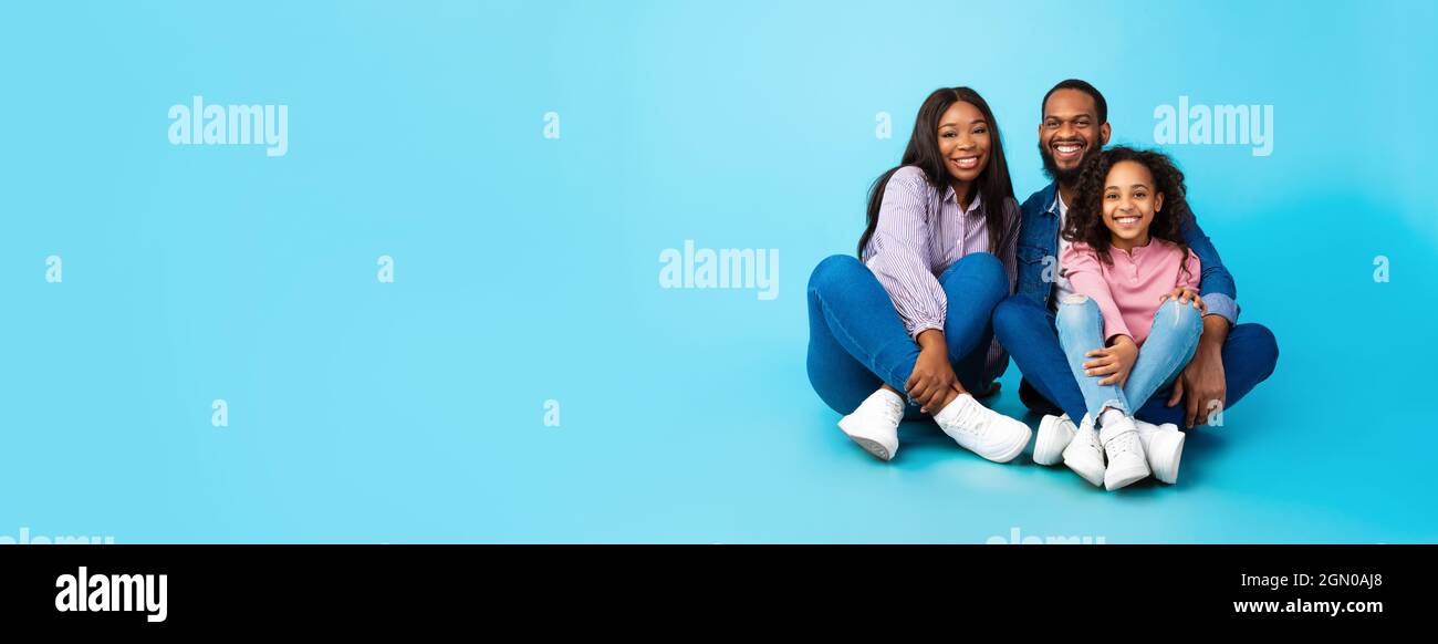 African American family posing sitting on the floor Stock Photo - Alamy