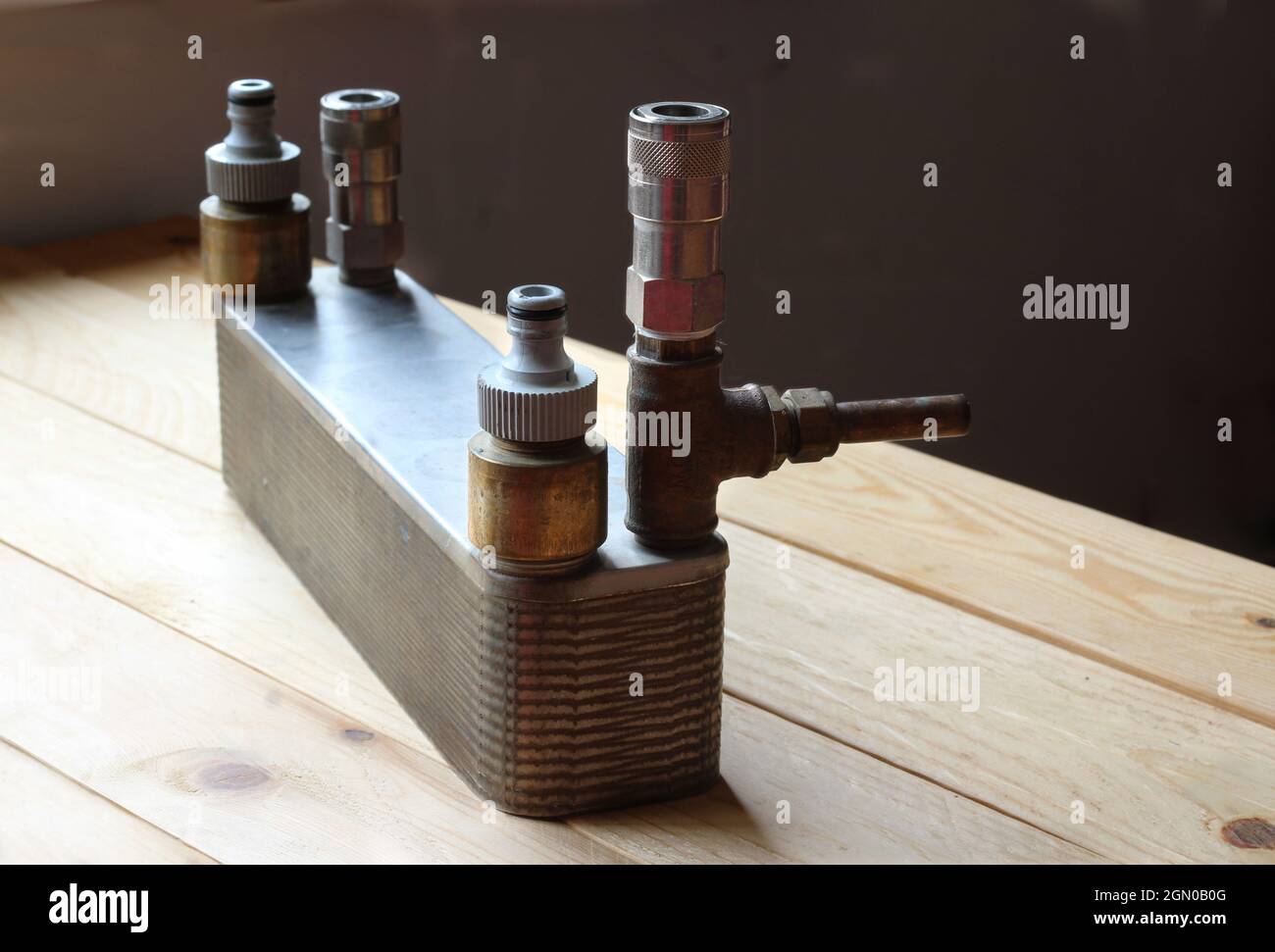 Close up image of a heat exchanger used for Home Beer Brewing. On a wooden table, ambient lighting, copyspace to right. Stock Photo