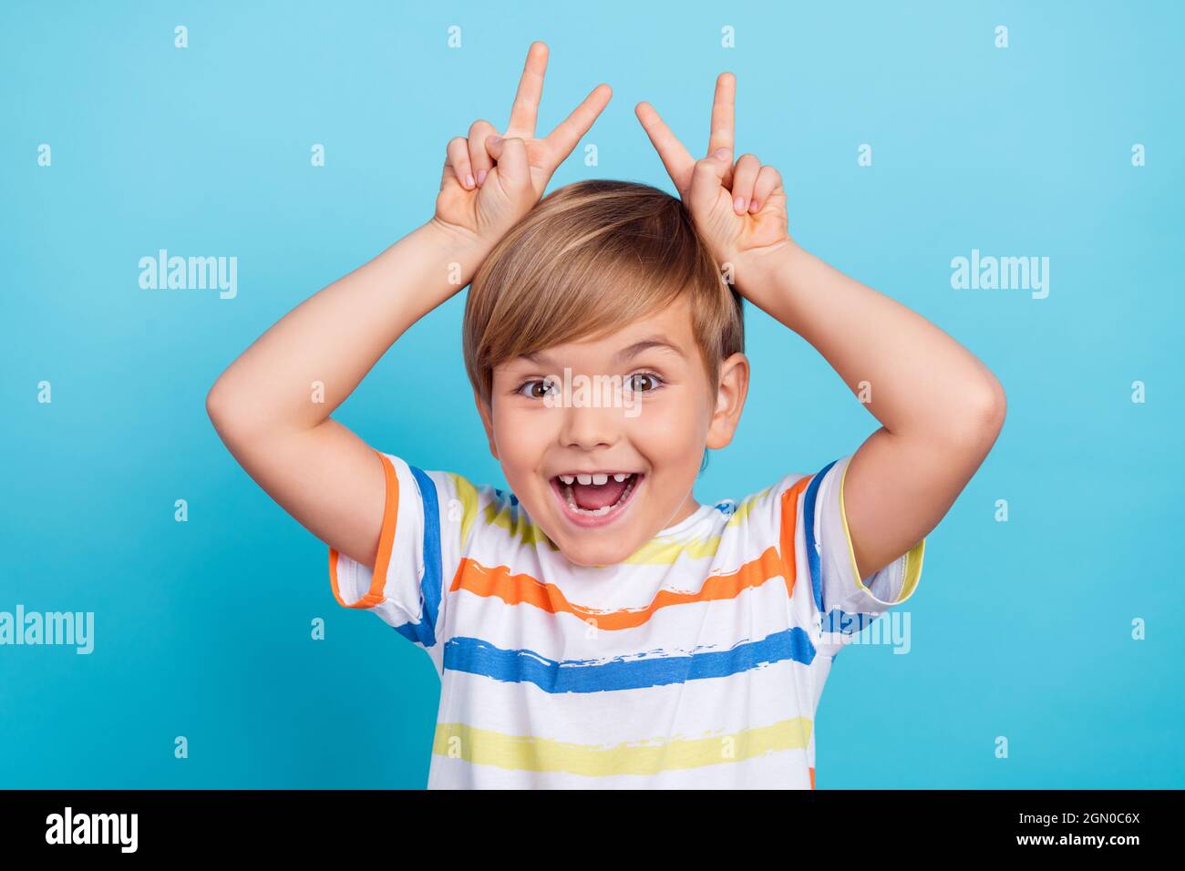 schoolboy mouth Photo of funky funny schoolboy make v-sign rabbit ear open mouth wear  striped t-shirt isolated blue color background Stock Photo - Alamy