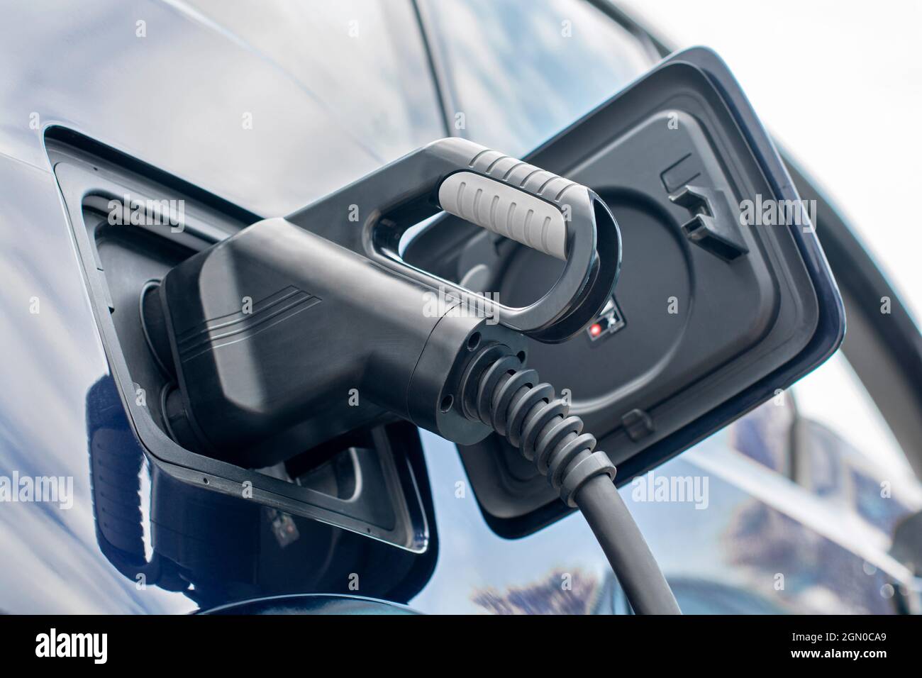 Power cable pump plug in charging power to electric car Stock Photo