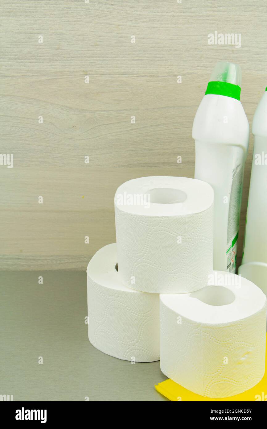 a roll of toilet paper and a bottle of detergent, cleanliness in the ...