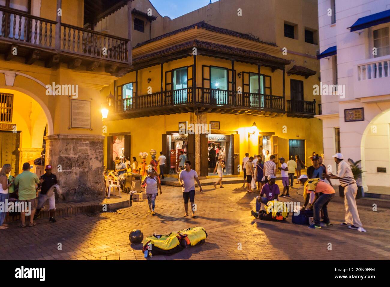 CARTAGENA DE INDIAS, COLOMBIA - AUG 27, 2015: People walk at the Plaza de los Coches in Cartagena during evening. Stock Photo
