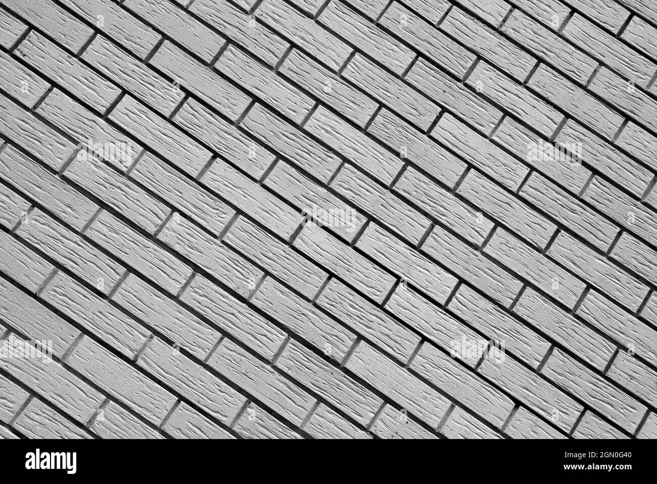Vintage black white brick wall background, diagonal position, stone
