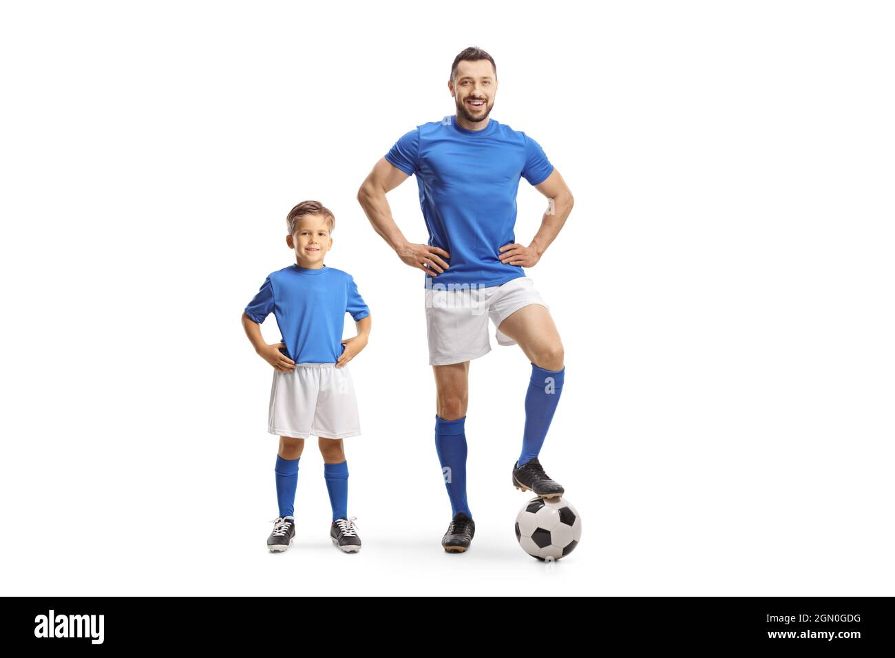 Young man and a boy with a soccer ball wearing blue sport jersey isolated on white background Stock Photo