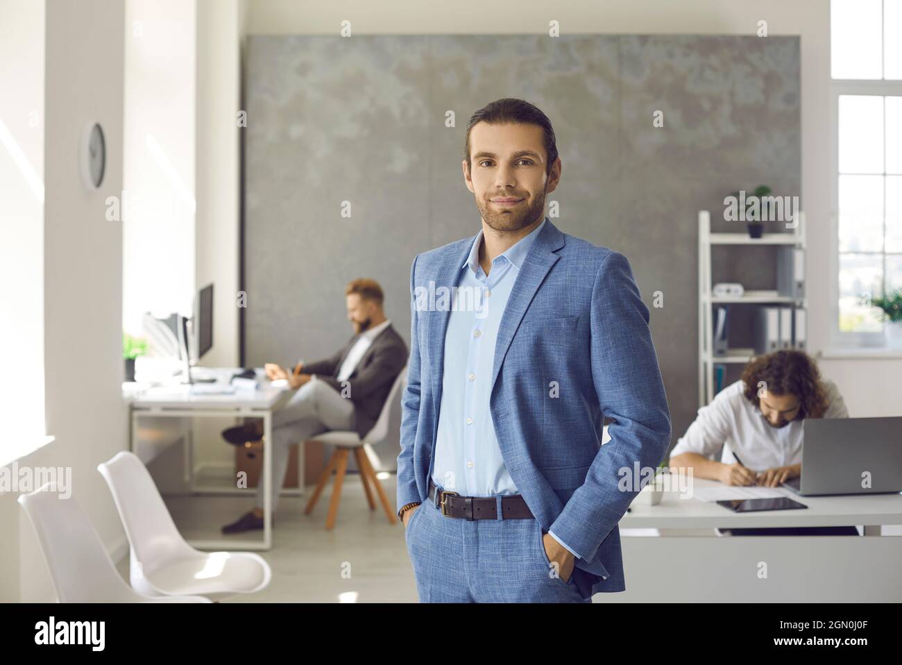 Portrait of successful businessman in suit in office Stock Photo