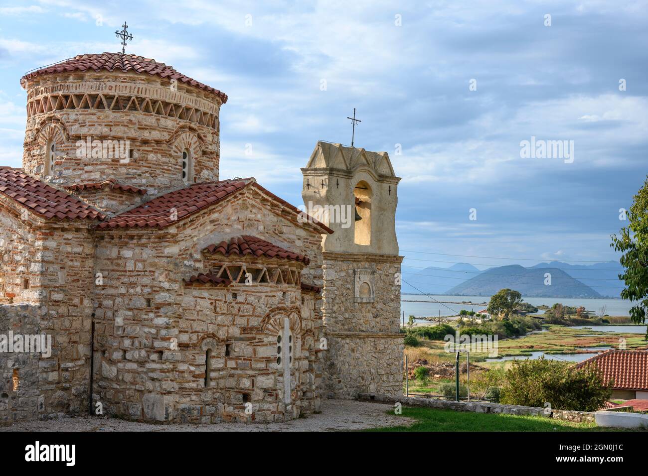 The little 10th cen. Byzantine church of  Panagia Koronisias in the village of Koronisia on Koronisia island with the Ambracian Gulf in the background Stock Photo