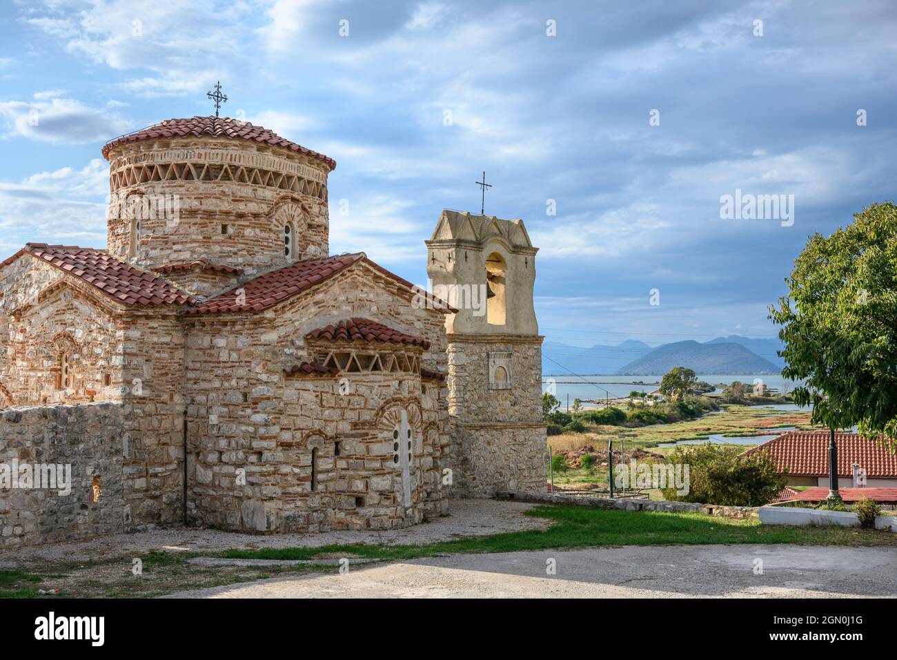 The little 10th cen. Byzantine church of  Panagia Koronisias in the village of Koronisia on Koronisia island with the Ambracian Gulf in the background Stock Photo