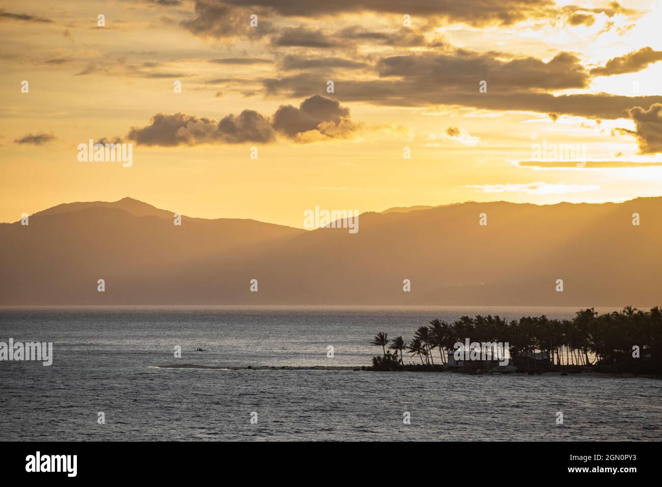 Palm trees on a peninsula with mountains in the distance at sunset, Barangay I, Romblon, Romblon, Philippines, Asia Stock Photo
