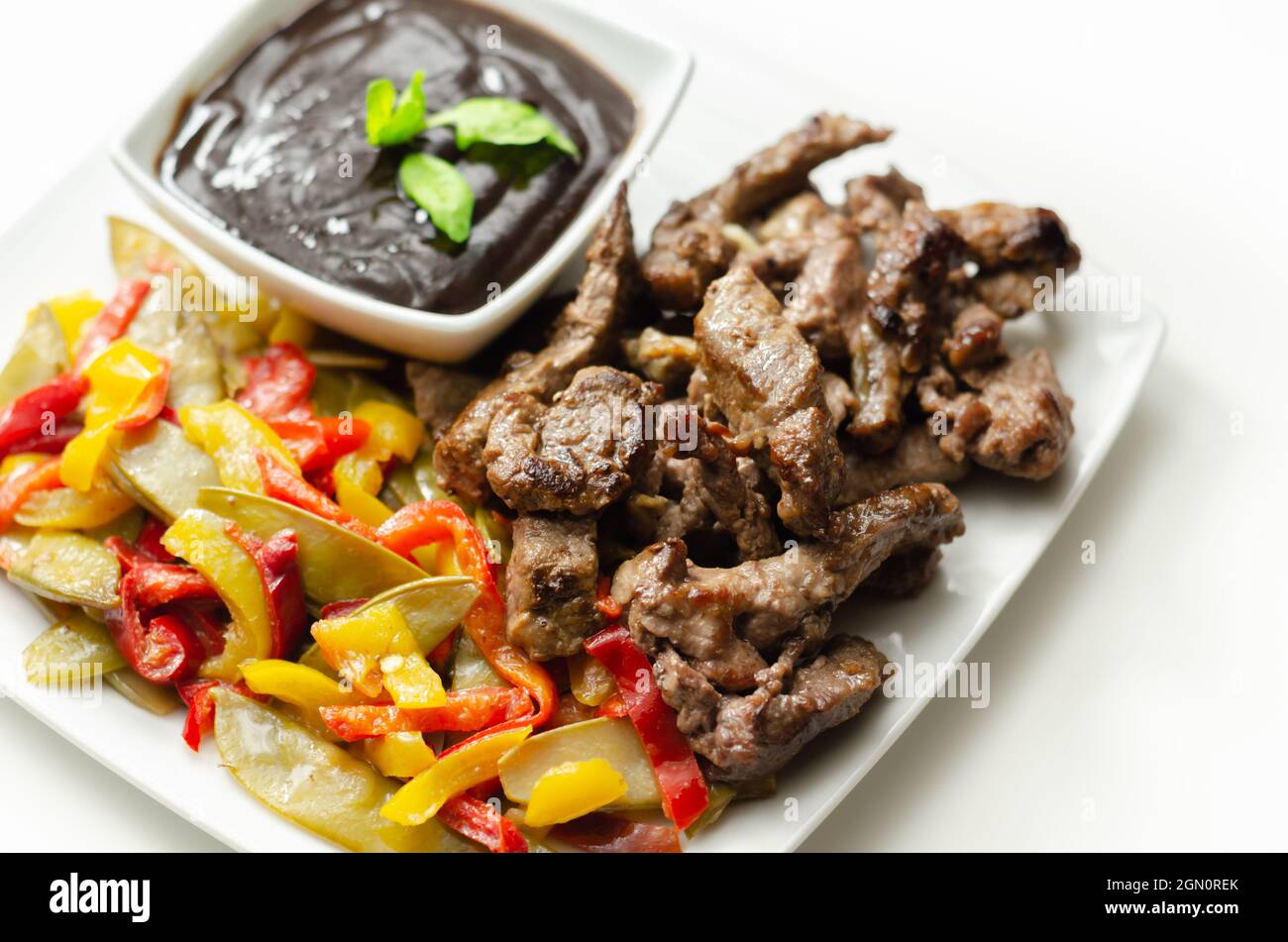 Beef strips with mixed peppers and mangetout served with black bean