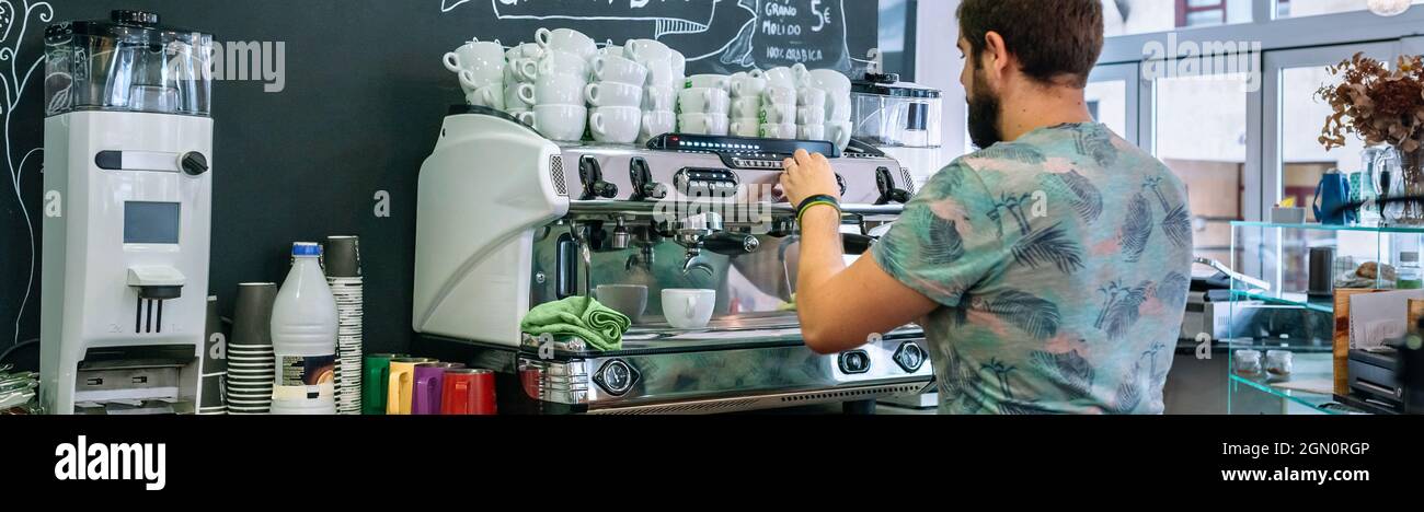 Male barista preparing coffee machine Stock Photo