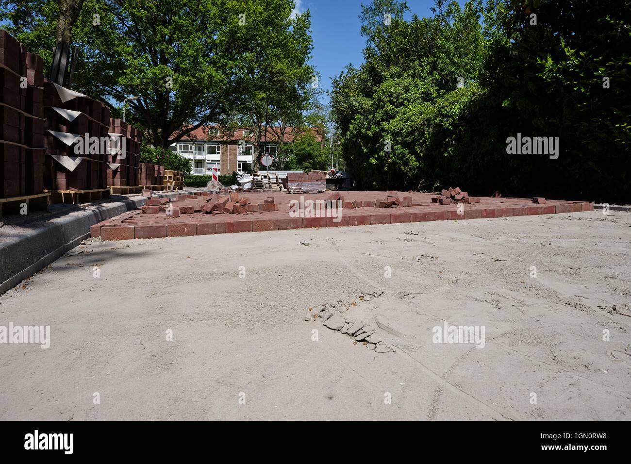 Construction of a cobblestone street. Pile of cobblestones with sand ...