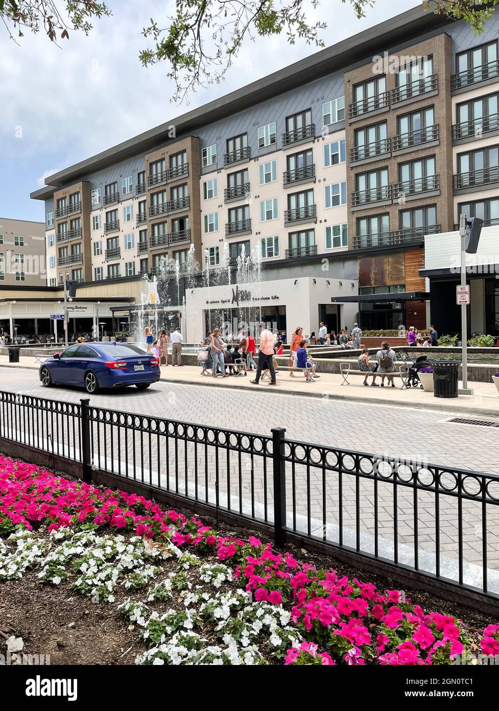 Plano, TX USA May 9, 2021 Roadside view of local residents hanging out around Legacy West in