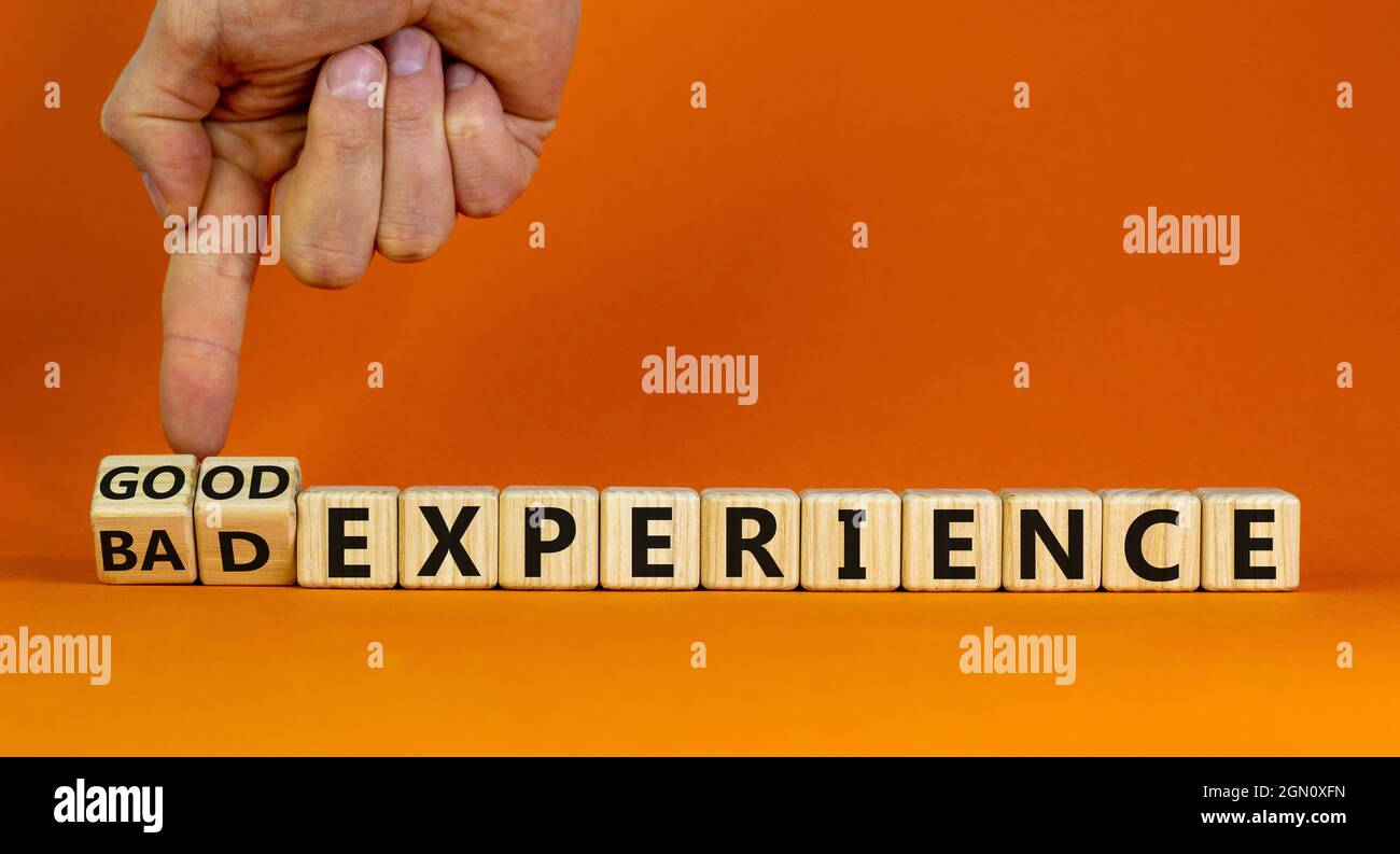 Good or bad experience symbol. Businessman turns wooden cubes, changes