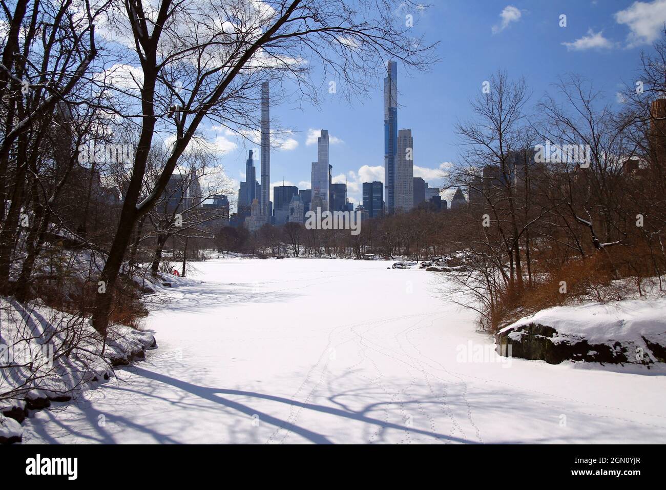 The spectacular skyscrapers of the billionaire row behind the snowy lake of Central Park in New York City Stock Photo