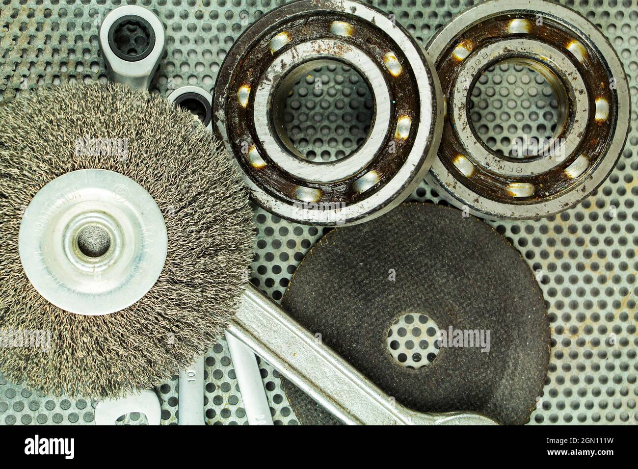 Metalworking tools, steel parts, a wrench, on the background of a metal lattice Stock Photo