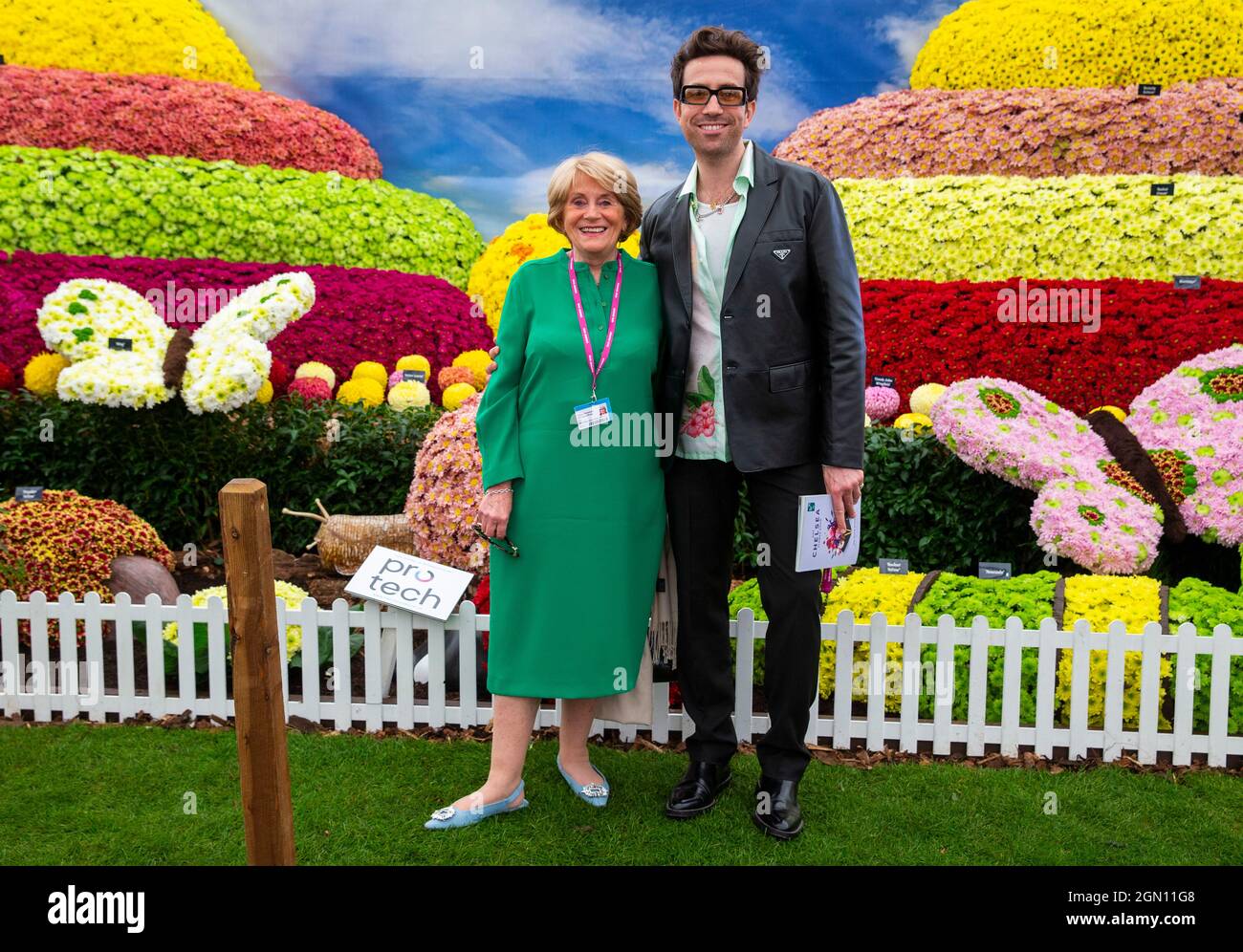 Disc Jockey and presenter, Nick Grimshaw and his mother pose with a vibrant floral display at the RHS Chelsea Flower Show Stock Photo
