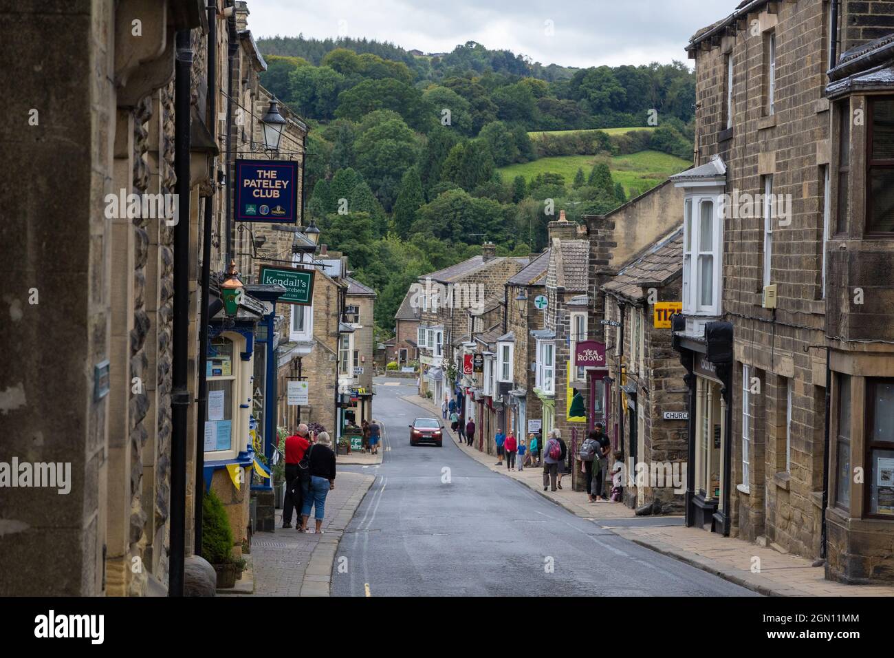 Pateley Bridge North Yorkshire. A view looking down the main street of Pateley. Trees and hills in the distance. Stock Photo
