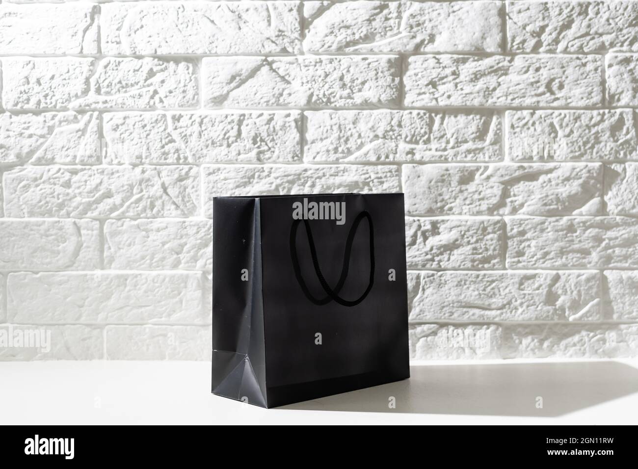 black paper bag with handles on a white background Stock Photo - Alamy