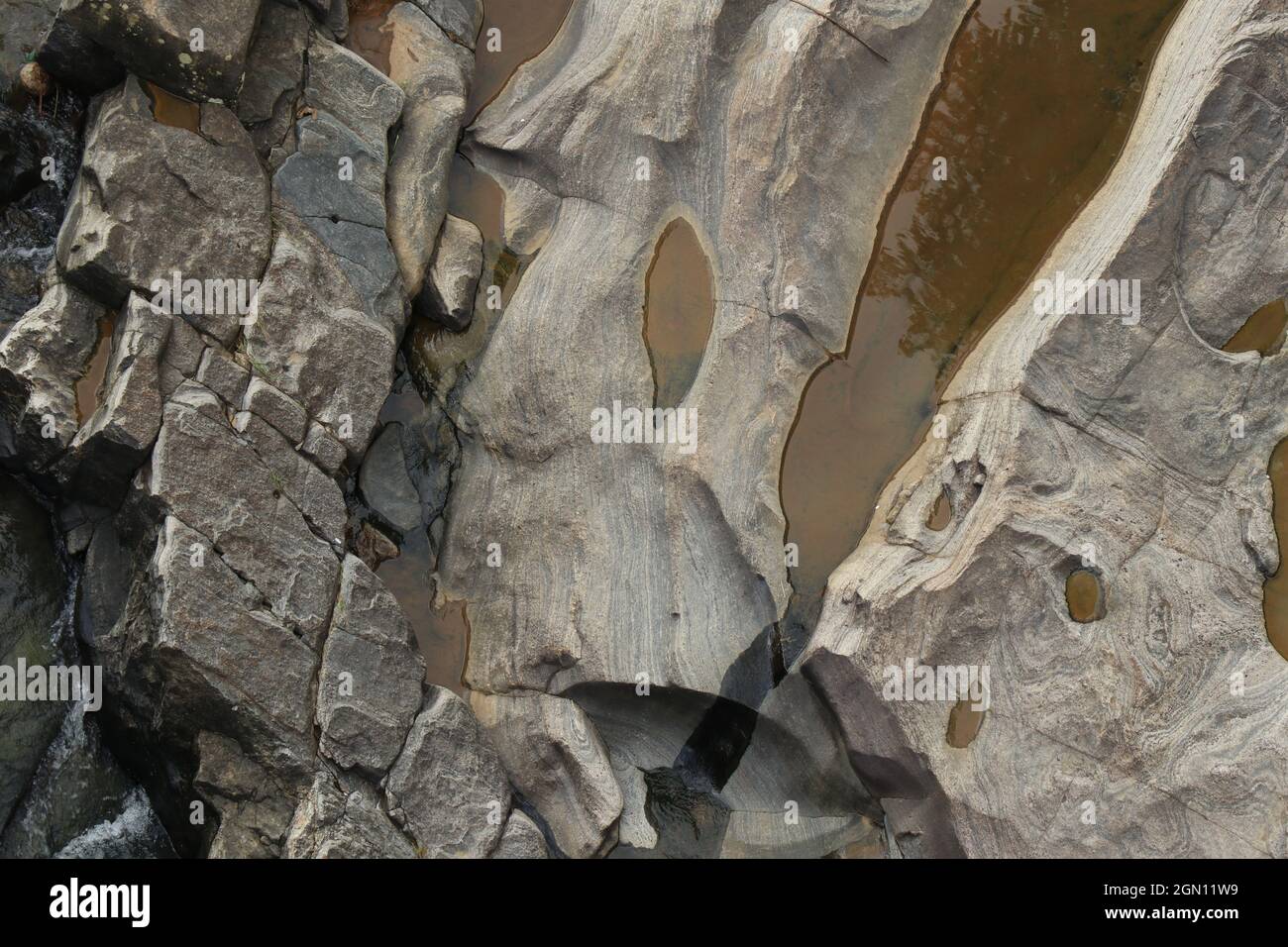 A stream flowing on the eroded rocks with creating a beautiful texture ...