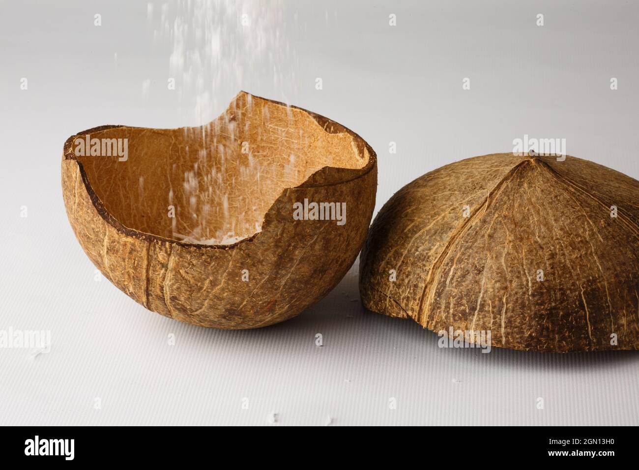 Coconut shell isolated on white background. The coconut flakes are removed from the inside of the coconut shell. Stock Photo