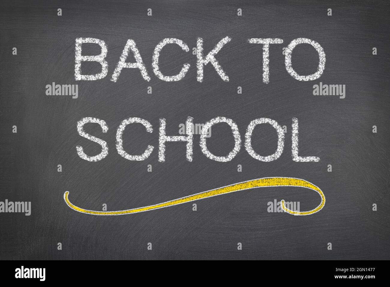 The words back to school are written on a blackboard, welcoming students to the classroom as teaching begins in the new year. Stock Photo