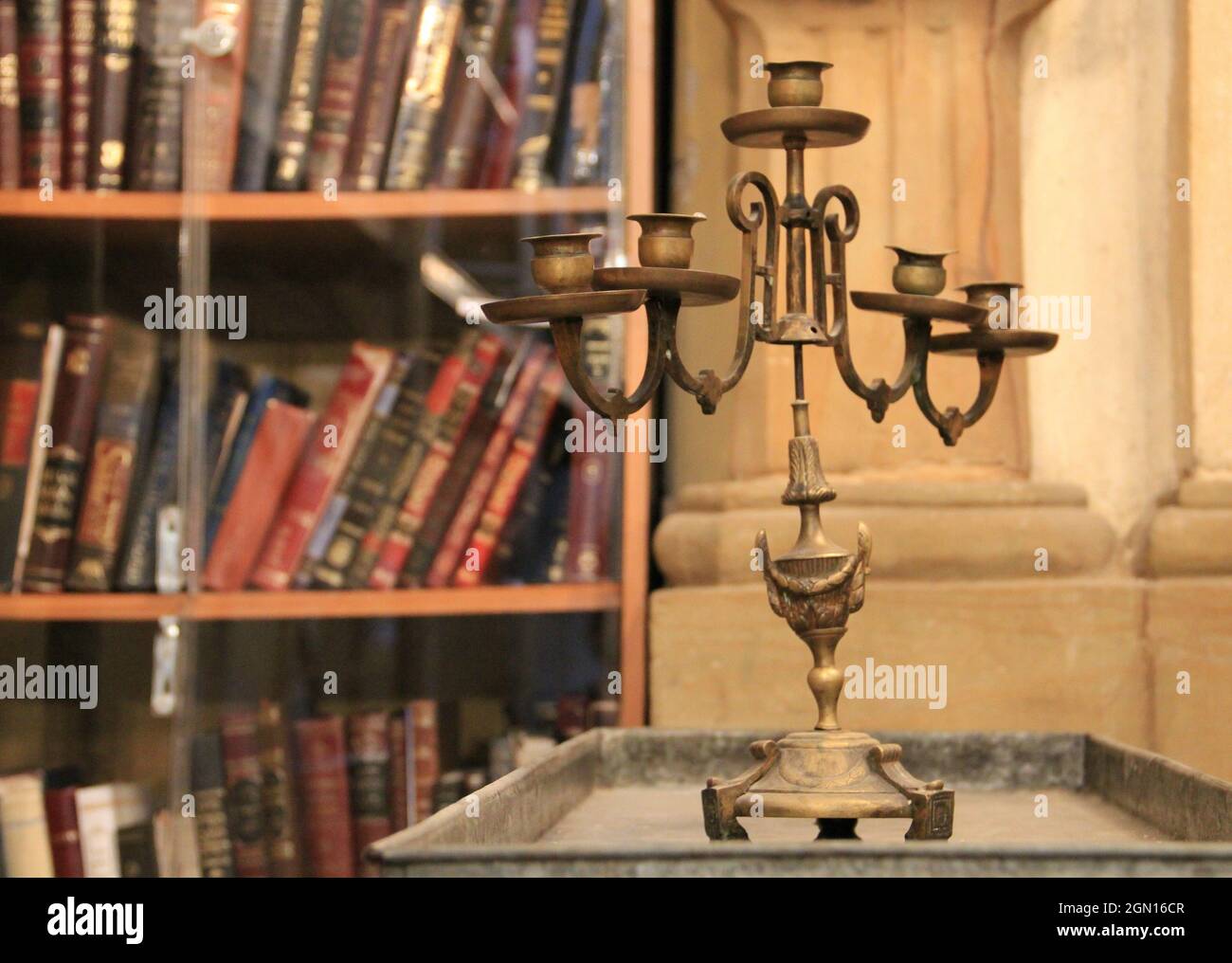 Old candle holder with a bookshelf background in Cracow, Polan Stock Photo Alamy