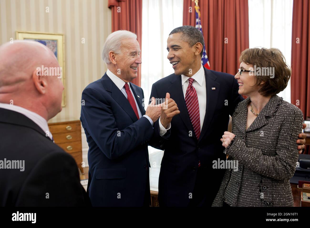 President Barack Obama and Vice President Joe Biden talk with former Representative Gabrielle Giffords and her husband, Mark Kelly, after the President signed H.R. 3801, the Ultralight Aircraft Smuggling Prevention Act of 2012, in the Oval Office, Feb. 10, 2012. The bill was the last piece of legislation that Giffords sponsored and voted on in the U.S. House of Representatives. (Official White House Photo by Pete Souza) This official White House photograph is being made available only for publication by news organizations and/or for personal use printing by the subject(s) of the photograph. Th Stock Photo