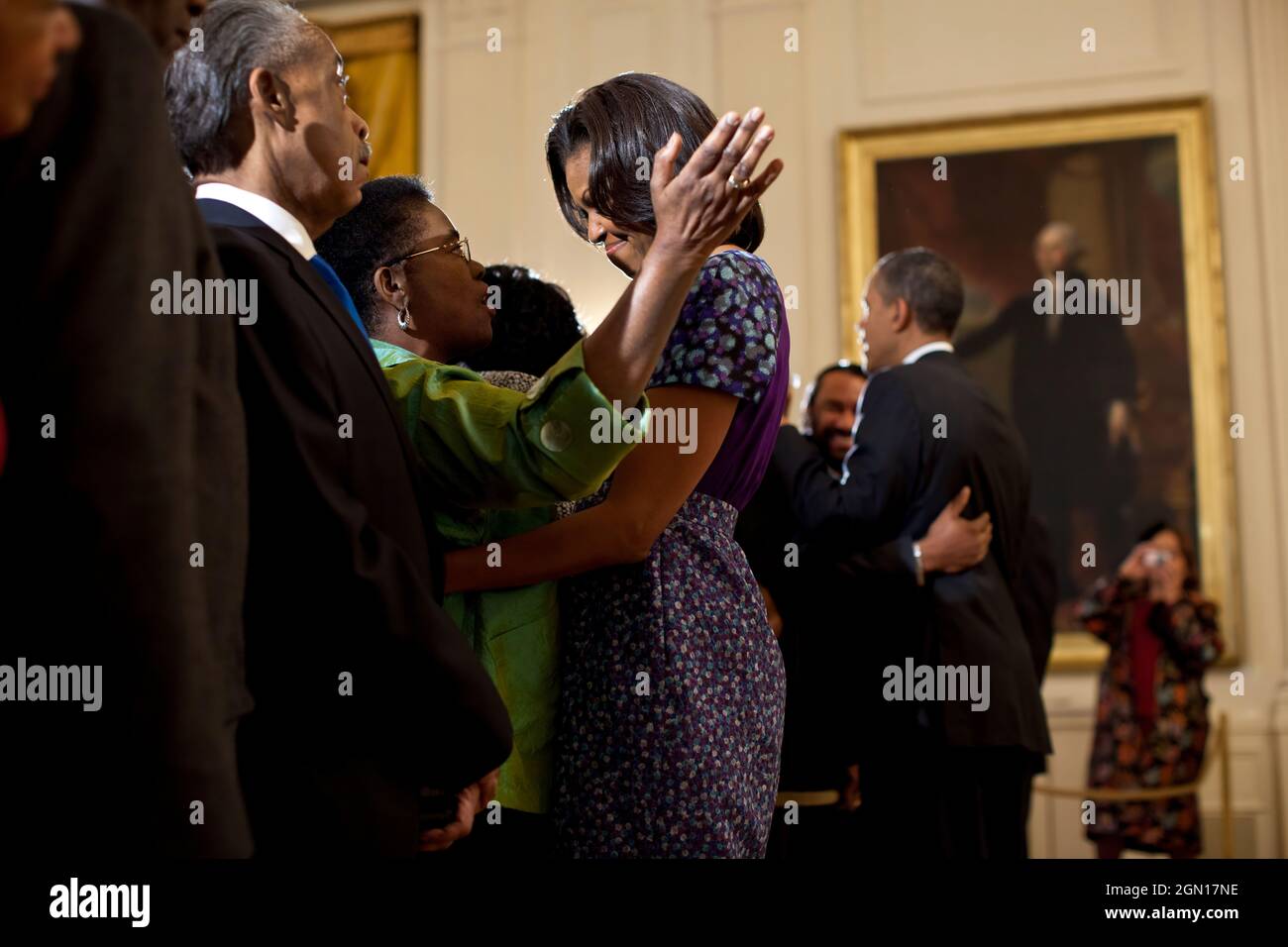 President Barack Obama and First Lady Michelle Obama greet guests during a reception in honor of the groundbreaking of the Smithsonian National Museum of African American History and Culture, in the East Room of the White House, Feb. 22, 2012. (Official White House Photo by Pete Souza) This official White House photograph is being made available only for publication by news organizations and/or for personal use printing by the subject(s) of the photograph. The photograph may not be manipulated in any way and may not be used in commercial or political materials, advertisements, emails, products Stock Photo