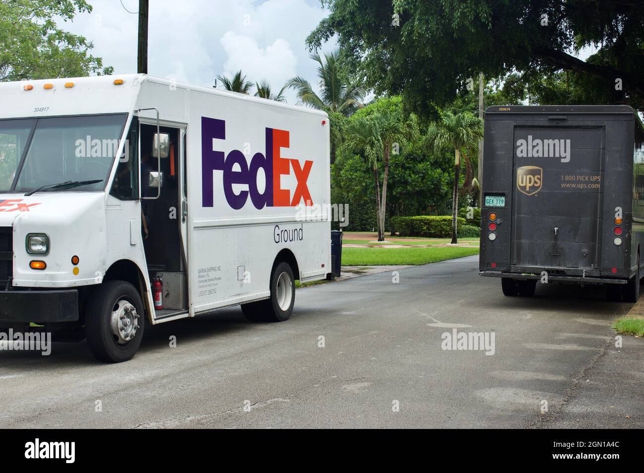 Fedex and UPS delivery vehicles at residential address Stock Photo - Alamy